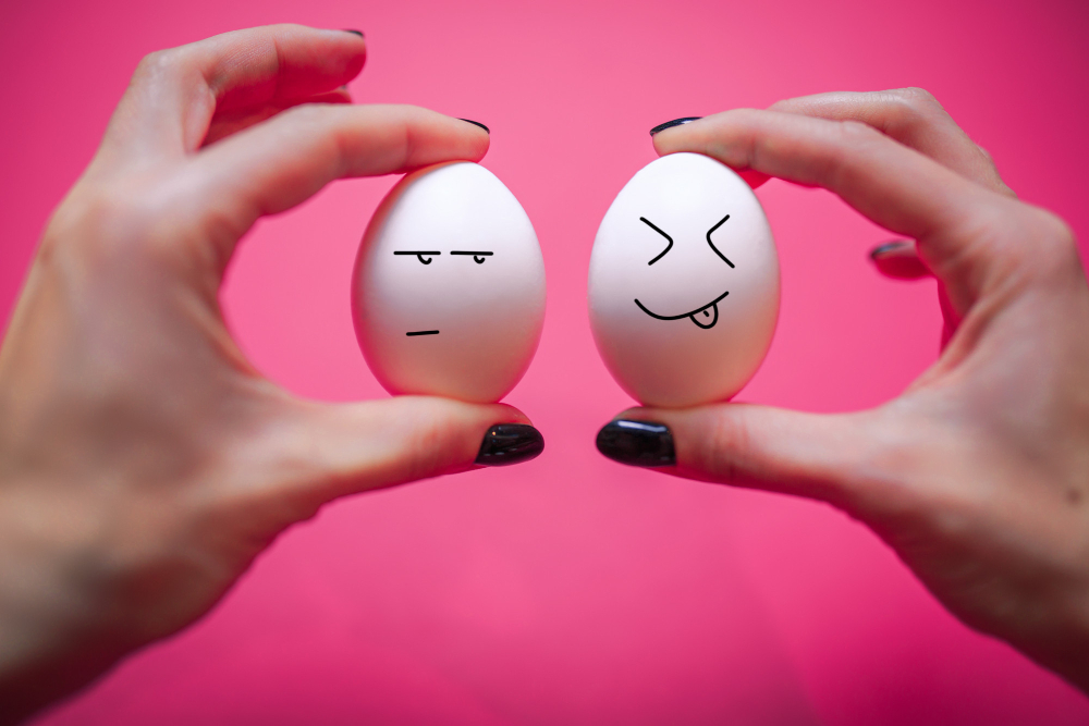 שתי ביצים עם פרצופים על רקע ורוד