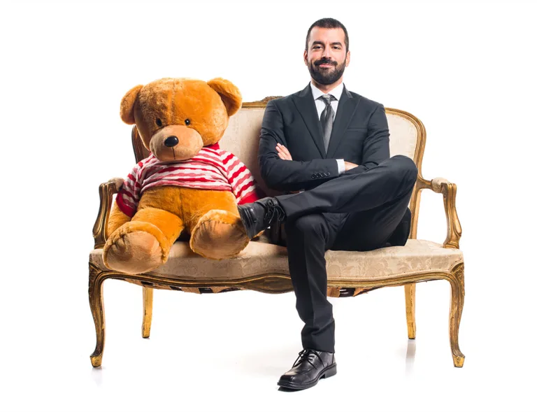 businessman-with-teddy-sitting-vintage-armchair