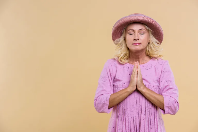 blonde-senior-woman-with-pink-hat-praying1